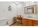 Charming powder room featuring a decorative vanity, granite countertop, and colorful floral accents at 10101 W 72Nd Ave, Arvada, CO 80005