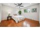 Bright bedroom with hardwood floors, natural light, and ceiling fan at 11457 Nancys Dr, Conifer, CO 80433