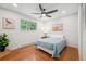 Cozy bedroom featuring hardwood floors, ceiling fan, and natural lighting at 11457 Nancys Dr, Conifer, CO 80433