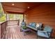 Inviting covered deck area with comfortable seating, perfect for relaxing and enjoying the wooded scenery at 11457 Nancys Dr, Conifer, CO 80433