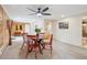 Bright dining area featuring a round table, red chairs, and access to an adjacent room with wooden paneling at 11457 Nancys Dr, Conifer, CO 80433