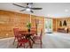 Cozy dining area with a round table, red chairs, and wooden paneling accents, with glass paneled door at 11457 Nancys Dr, Conifer, CO 80433