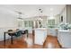 Bright kitchen features stainless steel appliances, a center island, and a dining area at 11457 Nancys Dr, Conifer, CO 80433