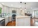 Modern kitchen with stainless steel appliances, quartz countertops, and a brick fireplace at 11457 Nancys Dr, Conifer, CO 80433