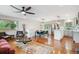 Open-concept living room featuring a stylish dining area, wood floors, and stainless steel appliances at 11457 Nancys Dr, Conifer, CO 80433