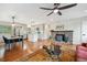 Open-concept living room with fireplace, adjacent to the updated kitchen with center island and stainless steel appliances at 11457 Nancys Dr, Conifer, CO 80433