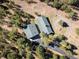 An aerial view of the home and detached garage surrounded by trees at 31948 Highway 72, Golden, CO 80403