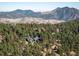 Expansive aerial view of a tree-filled property with a home nestled among the lush forest at 31948 Highway 72, Golden, CO 80403