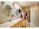 Spacious bathroom featuring double sinks, a glass block shower and access to a walk-in closet at 31948 Highway 72, Golden, CO 80403
