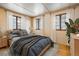 Comfortable bedroom filled with natural light from multiple windows, creating a cozy and inviting atmosphere at 31948 Highway 72, Golden, CO 80403