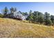 Beautiful mountain home with large windows, nestled among lush trees with scenic views at 31948 Highway 72, Golden, CO 80403