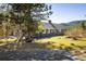Exterior of home surrounded by trees and decorative wheel at 31948 Highway 72, Golden, CO 80403