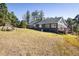 A charming exterior view of the home with a swing and expansive, treed yard at 31948 Highway 72, Golden, CO 80403
