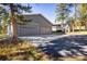 Large detached garage with a long driveway and house in background at 31948 Highway 72, Golden, CO 80403