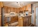 A kitchen with wood cabinets, a stainless steel refrigerator, and stylish decor at 31948 Highway 72, Golden, CO 80403