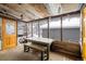 A rustic screened-in porch with a wooden table and bench, perfect for enjoying the outdoors at 31948 Highway 72, Golden, CO 80403