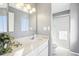 Updated bathroom with a white marble countertop, modern lighting, and a glass enclosed shower at 12097 E Mexico Ave, Aurora, CO 80012