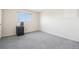 Bedroom with gray carpet, neutral walls, a window, and a small black dresser at 12097 E Mexico Ave, Aurora, CO 80012