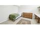 Bedroom features a bed, a wooden dresser, and an area rug at 12097 E Mexico Ave, Aurora, CO 80012