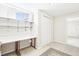 A bedroom area features a built-in desk, closet and window at 12097 E Mexico Ave, Aurora, CO 80012