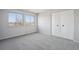 Neutral bedroom with large windows and closet at 12097 E Mexico Ave, Aurora, CO 80012