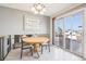 Bright dining room with tile flooring, a round table, and a sliding glass door to the deck at 12097 E Mexico Ave, Aurora, CO 80012