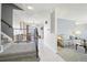 Bright foyer with staircase, neutral tile, and views into the dining and living areas at 12097 E Mexico Ave, Aurora, CO 80012