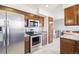 Modern kitchen featuring stainless steel appliances, granite countertops, and tiled flooring at 12097 E Mexico Ave, Aurora, CO 80012