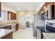 Well-lit kitchen boasts stainless steel appliances, granite countertops, and an adjacent dining area at 12097 E Mexico Ave, Aurora, CO 80012