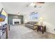 Open living room with a fireplace, comfortable sofa, and natural light at 12097 E Mexico Ave, Aurora, CO 80012