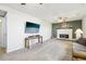 Open-concept living room featuring a fireplace and a mounted television at 12097 E Mexico Ave, Aurora, CO 80012