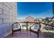 Inviting outdoor balcony showcasing seating with sunflower pillows and neighborhood views at 5654 N Emporia St, Denver, CO 80238