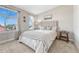 Cozy bedroom with two windows with sheer white curtains and a picture hanging on the wall at 5654 N Emporia St, Denver, CO 80238