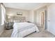 Cozy bedroom featuring neutral decor, a comfortable bed with upholstered headboard, and an adjacent doorway at 5654 N Emporia St, Denver, CO 80238