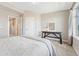 Bright bedroom showcasing a study nook with desk, a large window, and neutral decor at 5654 N Emporia St, Denver, CO 80238