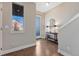 Bright foyer featuring wood floors, staircase, modern decor, window and neutral paint, creating a welcoming entrance at 5654 N Emporia St, Denver, CO 80238