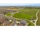 This aerial showcases a well-manicured community park with playgrounds, walking trails, and expansive green spaces at 1181 W 170Th Ave, Broomfield, CO 80023