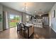 Bright dining area with wood floors, a stylish table set, and sliding door access to the backyard at 1181 W 170Th Ave, Broomfield, CO 80023