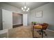 Comfortable home office featuring an adjustable chair, chandelier lighting, and a bright and inviting workspace at 1181 W 170Th Ave, Broomfield, CO 80023