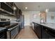 Modern kitchen with granite countertops, stainless steel appliances, and ample cabinet space for storage and functionality at 1181 W 170Th Ave, Broomfield, CO 80023