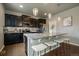 Modern kitchen featuring a granite island with stool seating, stainless steel appliances, and pendant lighting at 1181 W 170Th Ave, Broomfield, CO 80023