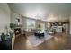 Open concept living room with a fireplace, dark floors and access to the kitchen at 1181 W 170Th Ave, Broomfield, CO 80023