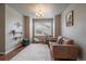 Bonus living room space with hardwood floors, a large window and a leather couch at 1181 W 170Th Ave, Broomfield, CO 80023