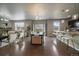 Open concept living space with hardwood floors, a dining area, a breakfast bar, and modern decor at 1181 W 170Th Ave, Broomfield, CO 80023