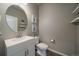 Half bathroom with a unique round mirror and a modern vanity at 1181 W 170Th Ave, Broomfield, CO 80023