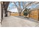 Backyard featuring a concrete patio, gravel beds, and wood fence surrounding the lawn at 2505 Upham St, Lakewood, CO 80214