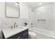 Modern bathroom with marble tile, gold fixtures, and vanity with drawers for ample storage at 2505 Upham St, Lakewood, CO 80214
