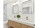 Modern bathroom featuring double vanity, quartz countertop, gold fixtures, and marble tiled shower at 2505 Upham St, Lakewood, CO 80214