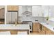 Modern kitchen featuring an island, stainless steel appliances, and ample cabinet space at 2505 Upham St, Lakewood, CO 80214