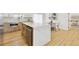 Close up view of the kitchen island with a quartz countertop and stainless steel appliances with seating and dining area at 2505 Upham St, Lakewood, CO 80214